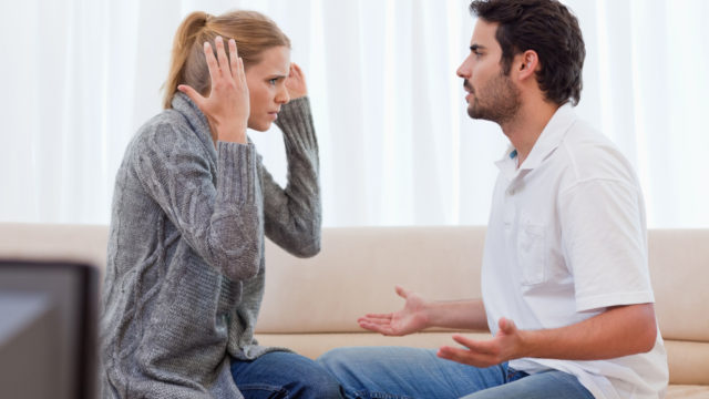 Young couple arguing in their living room