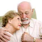 Elderly husband consoling wife
